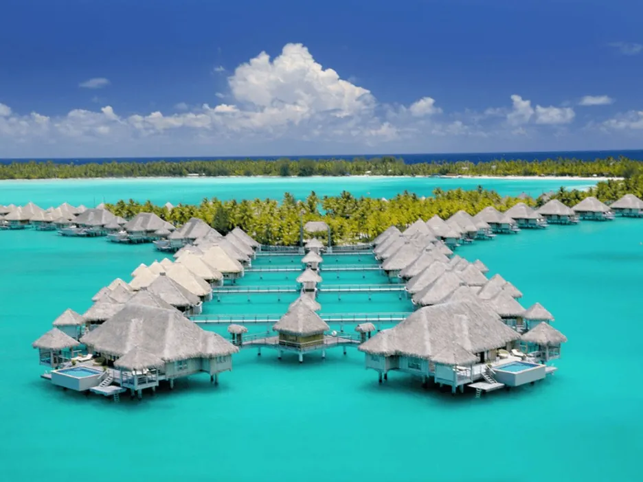 Overwater resort villas on turquoise water