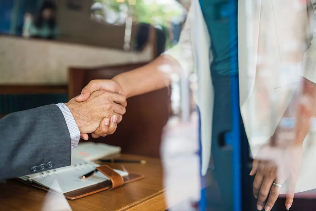 Handshake between a hotel professional and a partner