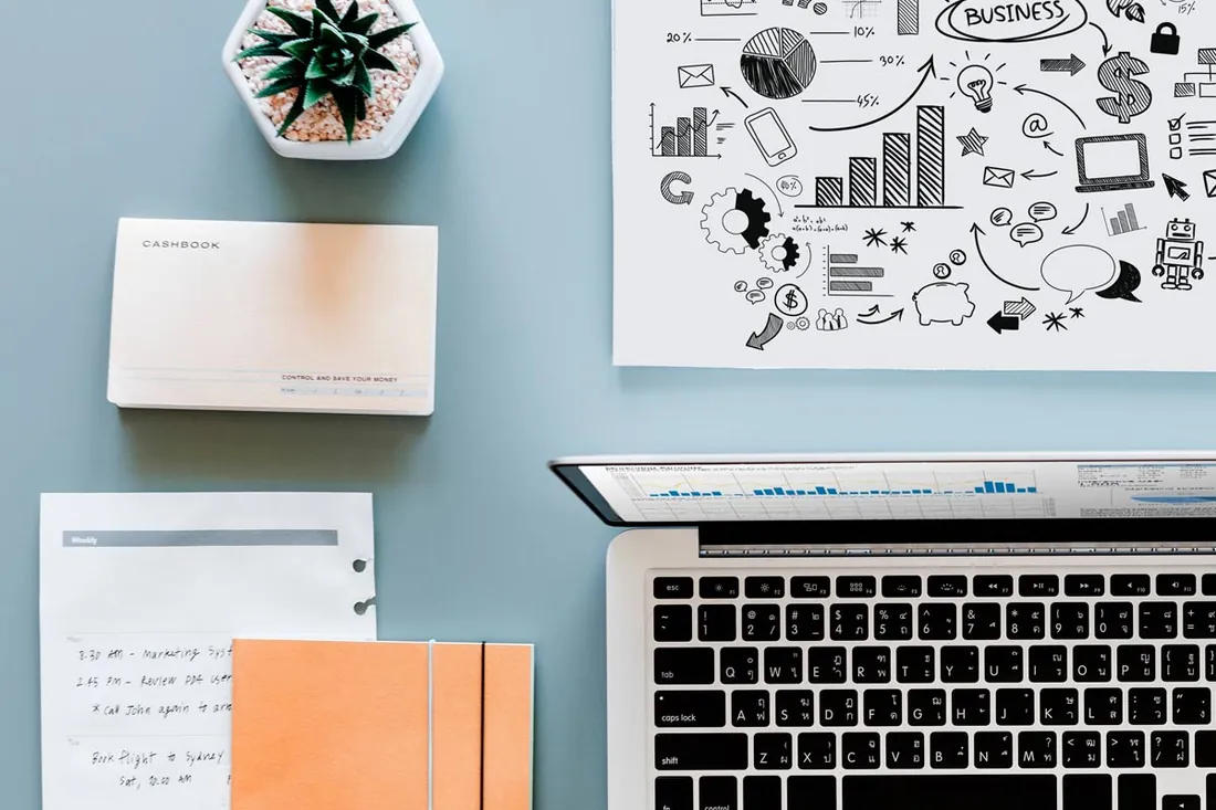 Laptop, notes and planning materials on a desk